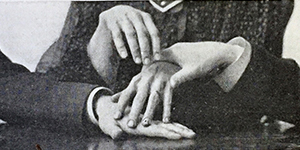 Hands holding a medium's hands